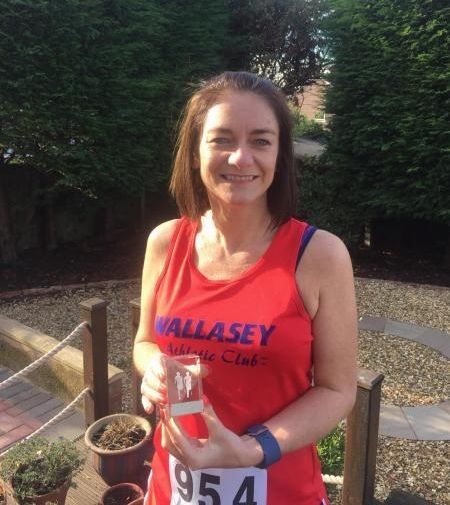 Jan McArd with her Wirral Seaside Run trophy for completing six out of the series of eight races.