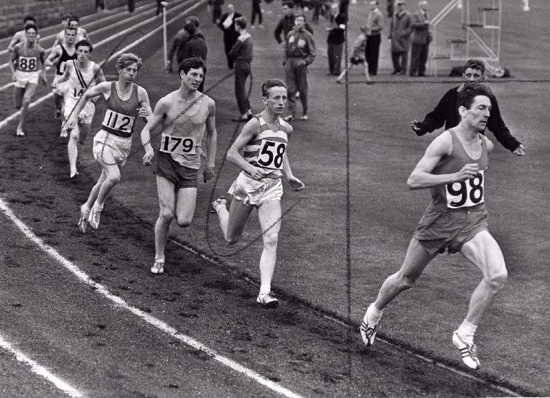 K. J. Mather (Wallasey A.C.) leads the field in the senior 880 yards and goes on to win with P. Howard (Manchester And District Lads Club) second in the Port Sunlight Athletics Club, Inter-Clubs championships held at the Oval, Bebington.